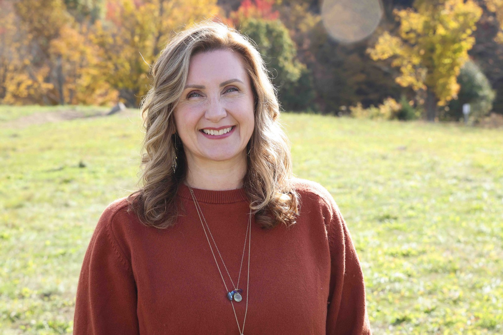 Christine Dorsey standing in an autumn field