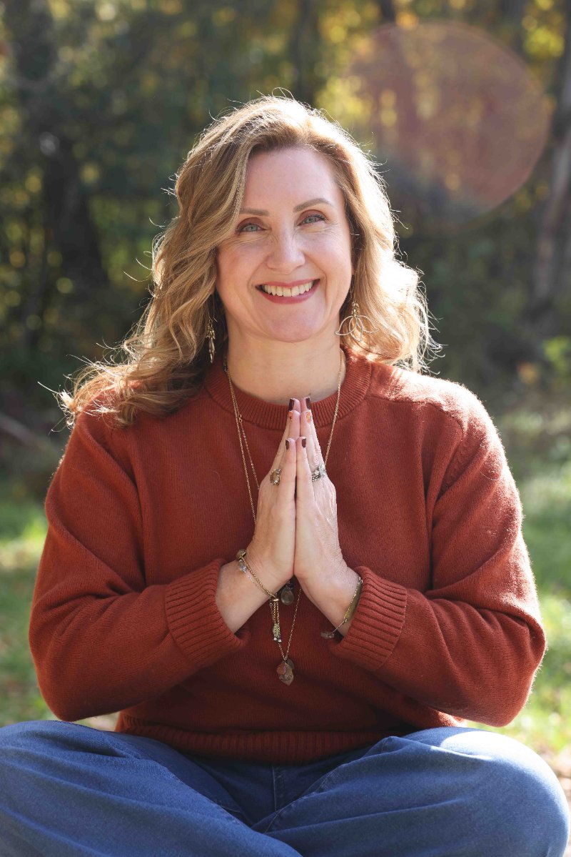 Christine Dorsey seated with hands in prayer position